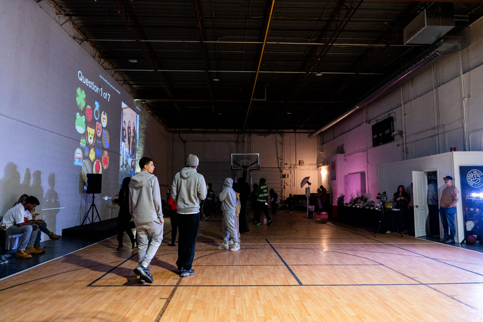 Guests on the court during a trivia game projected on the giant screen