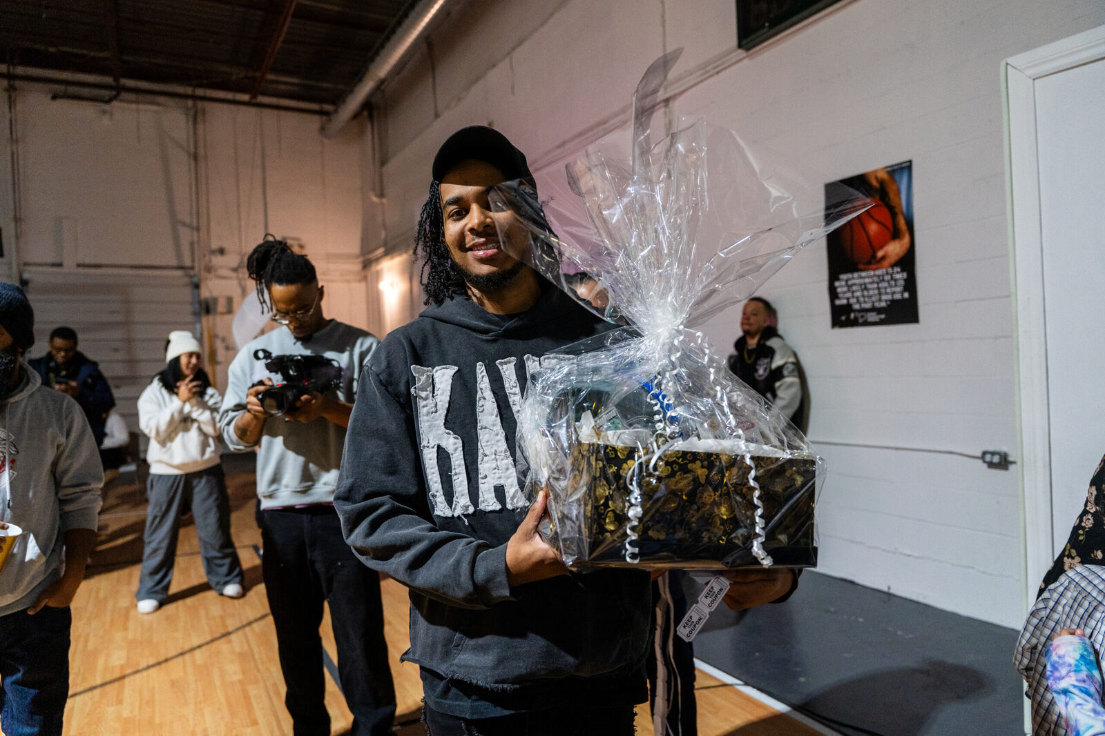 Young guest holding up a gift basket prize